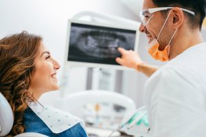 Image of woman looking at dental professional, explaining gum graft surgery. 